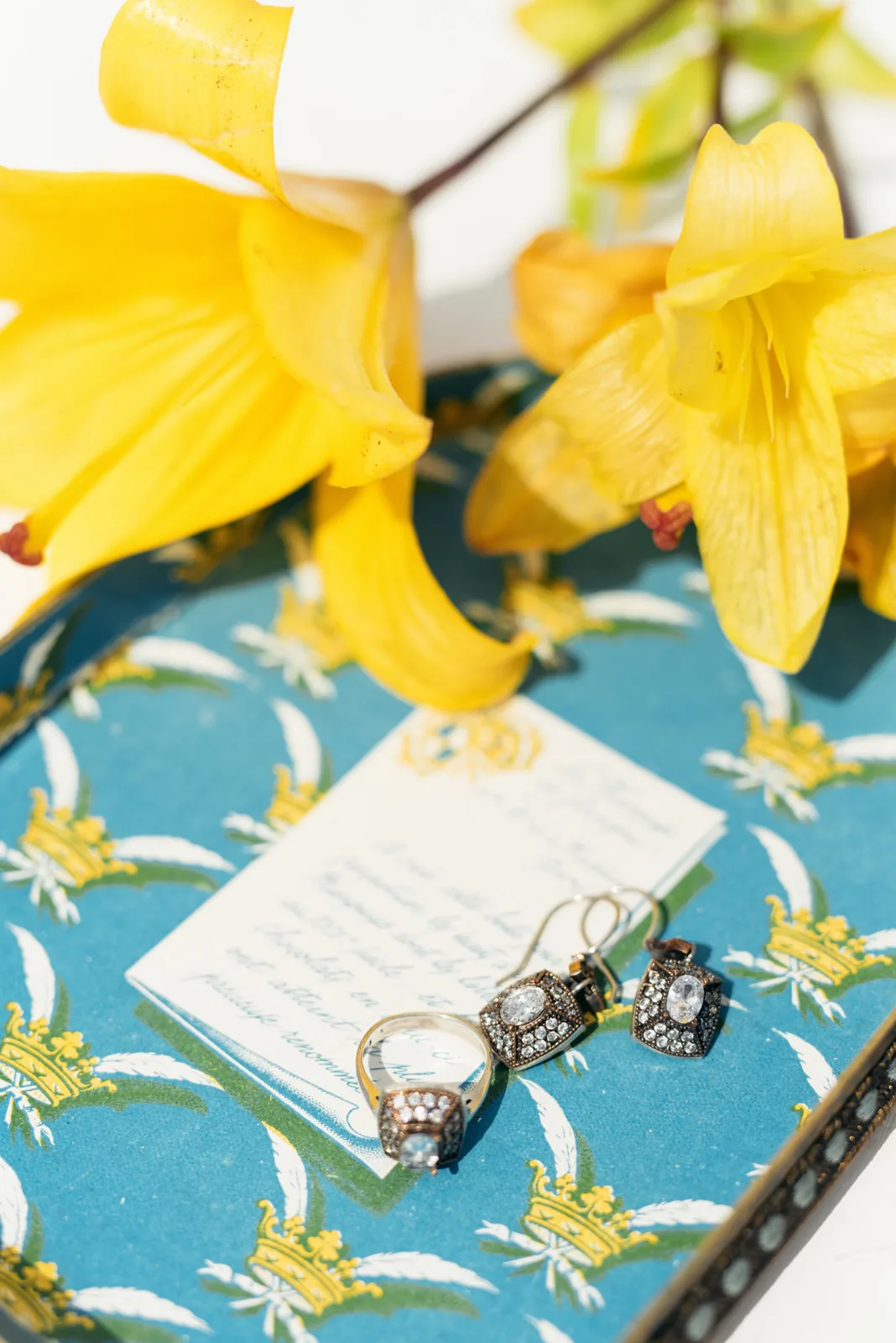 Vintage ring and earrings arranged with flowers