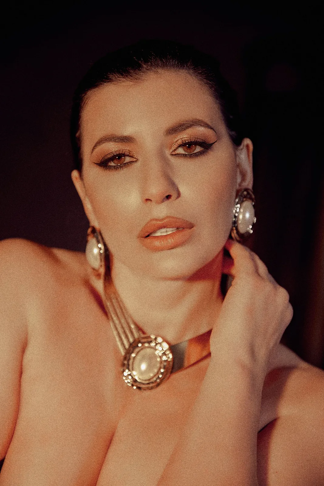 Editorial portrait featuring sculptural vintage-style jewelry